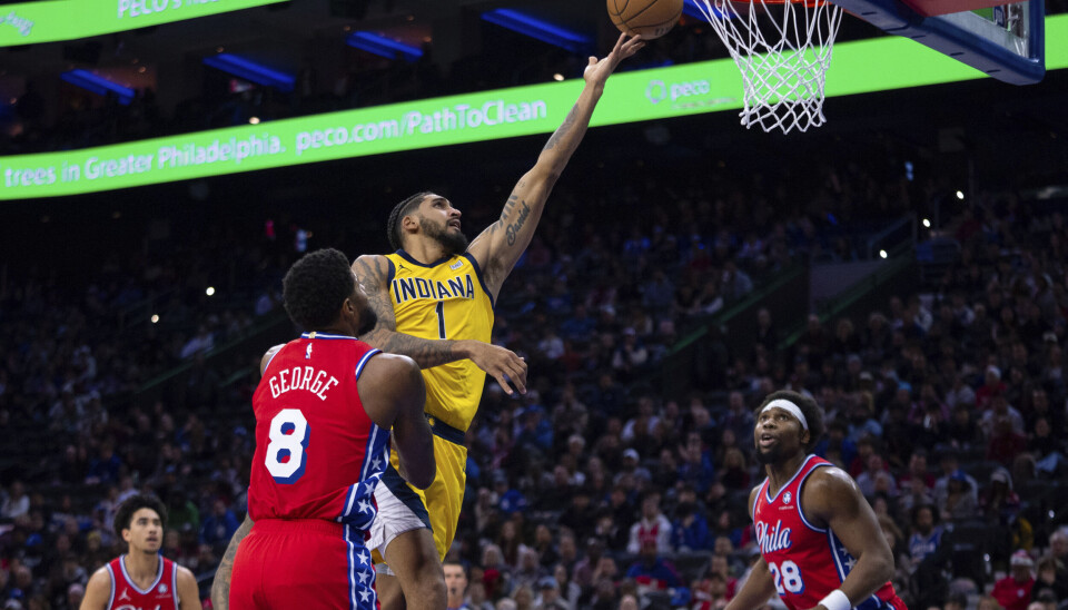 Indiana Pacers' Obi Toppin (1) goes up to shoot with Philadelphia 76ers' Paul George (8) defending during the second half of an NBA basketball game, Friday, Dec. 13, 2024, in Philadelphia. (AP Photo/Chris Szagola)