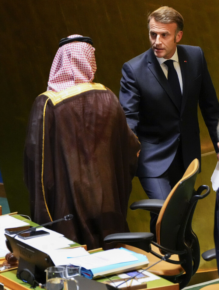 CORRECTS ID: Saudi Arabia Foreign Minister Faisal bin Farhan Al-Saud, left, greets France President Emmanuel Macron, center, as they prepare to lead a high-profile meeting at the United Nations aimed at galvanizing support for a two-state solution to the Israeli-Palestinian conflict Monday, Sept. 22, 2025, at UN headquarters. (AP Photo/Yuki Iwamura)