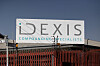 Idexis Compounding Specialists building seen behind a red metal fence in Pretoria.