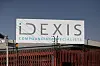 Idexis Compounding Specialists building seen behind a red metal fence in Pretoria.