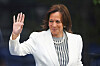 Kamala Harris waves in a white blazer and striped blouse at the Obama Presidential Center dedication ceremony.